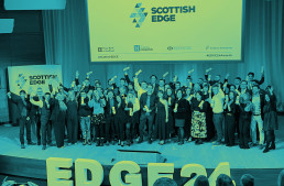 A gathering of people on stage celebrating their EDGE Round 24 Success